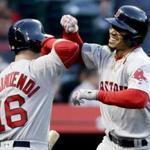 Boston Red Sox's Mookie Betts celebrates his home run with Andrew Benintendi, during the first inning of a baseball game against the Anaheim Angels in Anaheim, Calif., Thursday, April 19, 2018. (AP Photo/Chris Carlson)