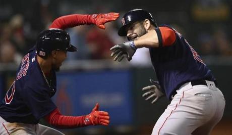 Boston Red Sox's Mitch Moreland, right, celebrates with Mookie Betts after hitting a grand slam off Oakland Athletics' Emilio Pagan during the sixth inning of a baseball game Friday, April 20, 2018, in Oakland, Calif. (AP Photo/Ben Margot)
