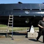 FILE - This April 30, 2008 file photo shows a submarine and its owner Peter Madsen. One of the most talked-about and macabre court cases in recent Danish history is set to conclude Wednesday, April 25, 2018 when the verdict is handed down on whether Peter Madsen tortured and murdered a Swedish journalist during a private submarine trip. (Niels Hougaard/Ritzau via AP, File)