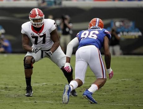 File-This Oct. 28, 2017, file photo shows Georgia offensive tackle Isaiah Wynn (77) looking to block Florida defensive lineman Cece Jefferson (96) in the first half of an NCAA college football game, in Jacksonville, Fla. Wynn was selected to the AP All-America team announced Monday, Dec. 11, 2017. (AP Photo/John Raoux, File)

