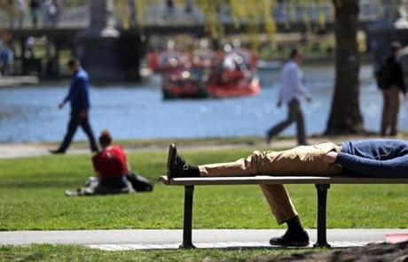 A man laid down in the sun and put his foot up at the Boston Public Garden during a warm day last week. 
