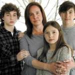 Alexis Weisz (second from left) posed with her children (left to right) Maxwell, 13, Grace, 11, and Logan, 16, at their home in Bedford. Weisz?s husband, Christopher, was struck and killed last year, allegedly by a driver with past drunken driving convictions.