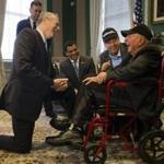 Boston, Massachusetts - 4/30/2018 - Massachusetts Governor Charlie Baker laughs with World War II veteran Sidney Walton(R), 99, and his son Paul(2nd R) at the State House in Boston, Massachusetts, April 30, 2018. Baker is the second governor to meet Walton on his journey to visit all 50 states. (Keith Bedford/Globe Staff)