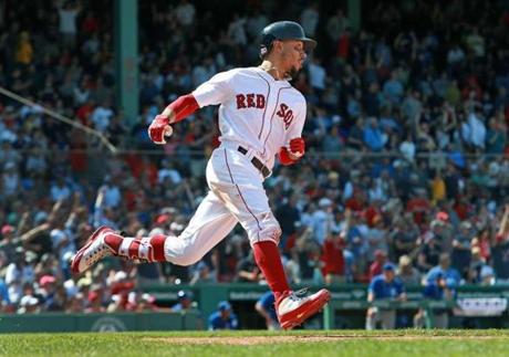 Boston, MA: 5-2-18: The Red Sox Mookie Betts (50) rounds first base as he watches his bottom of the 7th inning home run,his third round tripper of hte game leave the yard. The Boston Red Sox hosted the Kansas City Royals in a regular season MLB baseball game at Fenway Park. (Jim Davis/Globe Staff)
