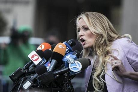 FILE-- Stephanie Clifford, the porn star better known as Stormy Daniels, speaks to reporters outside a federal courthouse after a hearing involving Michael Cohen, President Donald Trump's longtime personal lawyer, in New York, April 16, 2018. Lawyers for Clifford filed a defamation lawsuit against Trump on April 30, based on statements he made on Twitter two weeks ago that questioned her credibility. (Jeenah Moon/The New York Times)
