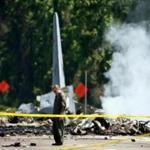 The tail of a military C-130 plane stood up from the road as emergency crews worked the site of the crash in Port Wentworth, Georgia on Wednesday.