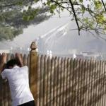 A boy leaned against a fence as he watched firefighters battle the blaze in Chelsea on Wednesday.