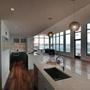 Pier 4 model home interiors with two different styled kitchens and view of Boston Harbor.