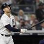 New York Yankees designated hitter Giancarlo Stanton watches his solo home run during the fourth inning of a baseball game against the Boston Red Sox in New York, Tuesday, May 8, 2018. (AP Photo/Kathy Willens)