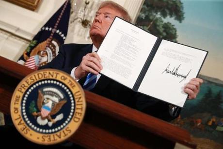 President Donald Trump holds up a memorandum that reinstates sanctions on Iran after he announced his decision to withdraw the United States from the 2015 Iran nuclear deal on Tuesday.
