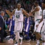 Boston, MA: 5-3-18: After he wrapped up the scoring as well as the game for the Celtics with a driving layup with 8.3 seconds left in the fourth quarter, the Celtics Al Horford was all smiles, but 76ers head coach Brett Brown (backround left) was not. The Boston Celtics hosted the Philadelphia 76ers in Game Two of their NBA Eastern Conference Semi Final playoff series at the TD Garden. (Jim Davis/Globe Staff)