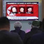 People watched a TV news report screen showing portraits of three Americans, Kim Dong Chul (left) Tony Kim and Kim Hak Song (right), detained in the North Korea at the Seoul Railway Station in Seoul, South Korea.