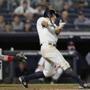 New York Yankees' Brett Gardner hits a two-run triple during the eighth inning of a baseball game against the Boston Red Sox in New York, Wednesday, May 9, 2018. Red Sox catcher Christian Vazquez is behind the plate. (AP Photo/Kathy Willens)