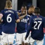 New England Revolution's Cristian Penilla, center, celebrates his second goal during the first half of an MLS soccer game against Toronto FC in Foxborough, Mass., Saturday, May 12, 2018. (AP Photo/Michael Dwyer)