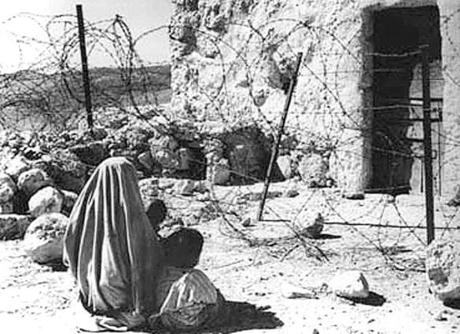 A Palestinian refugee and her child separated from their home by the ?green line? after the 1948 war.
