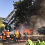Firefighters battled flames after a bomb was set off at a church in Surabaya, Indonesia. 
