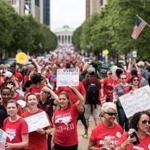 Mandatory Credit: Photo by CAITLIN PENNA/EPA-EFE/REX/Shutterstock (9677774b) Protestors gather in the streets during a North Carolina public school teacher march and rally in Raleigh, North Carolina, USA, 16 May 2018. The teachers are asking for high salaries and more school funding from the North Carolina legislature. North Carolina public school teacher march in Raleigh, North Carolina, USA - 16 May 2018