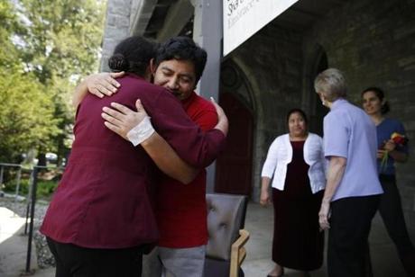 Amherst, MA--5/17/2018-- Lucio Perez (C) embraced Milta Franco, of Springfield after he came out to thank supporters who created a caravan to help him return to the church where he has been sheltered in sanctuary for the past seven months after a trip to the hospital for an emergency appendectomy. Clergy members and supporters created a caravan to shepherd him from the hospital in Northampton back to the church in Amherst so that ICE wouldn't try to detain him as he left. (Jessica Rinaldi/Globe Staff) Topic: 17sanctuarypic Reporter:
