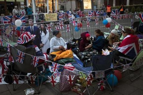 Fans hold a spot at the front of barriers for the carriage procession outside Windsor Castle.
