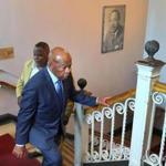 Representative John Lewis walks up the stairs past a photograph of Martin Luther King Jr. at the Twelfth Baptist Church in Roxbury on Saturday. 