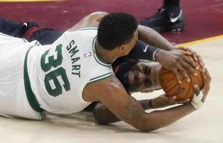 Cleveland Cavaliers' LeBron James, rear, and Boston Celtics' Marcus Smart battle for the ball during the second half of Game 6 of the NBA basketball Eastern Conference finals Friday, May 25, 2018, in Cleveland. The Cavaliers won 109-99. (AP Photo/Ron Schwane)
