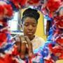 JROTC student Angel Clarke finished up the flowers on a Memorial Day wreath she was making in a classroom at the Community Academy of Science and Health.