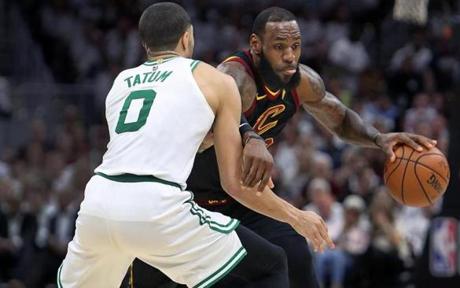 Cleveland, OH: 5-25-18: The Cavaliers LeBron James moves past the Celtics Jayson Tatum in first quarter action. The Boston Celtics visited the Cleveland Cavaliers for Game Six of their NBA Eastern Conference Finals playoff series at the Quicken Loans Arena. (Jim Davis/Globe Staff)
