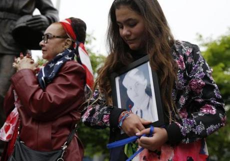 Boston, MA--5/28/2018-- Luna S?nchez, 12, of Boston (R) holds a picture of her grandfather, Luis S?nchez who served in World War II as she stands beside her grandmother, Maria S?nchez, at the Puerto Rican Veterans Association Memorial Day event. (Jessica Rinaldi/Globe Staff) Topic: 29memorialday Reporter: 
