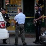 Police stood at the crime scene near the entrance of a Hyde Park barbershop on Tuesday. 