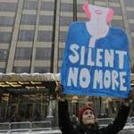 Mandatory Credit: Photo by PETER FOLEY/EPA-EFE/REX/Shutterstock (9266008d) A protester hold up a sign at a #MeToo rally in front of the Trump International Hotel at Columbus Circle in New York, New York, USA, 09 December 2017. MeToo Rally New York, USA - 09 Dec 2017