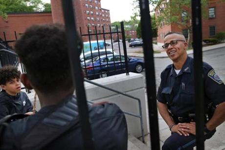 Boston Police Officer Jorge Dias chatted with two youths at the Mildred C. Hailey Apartments in Jamaica Plain.
