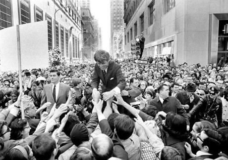 Presidential candidate Robert F. Kennedy, surrounded by hundreds of people who jammed a center-city street corner in Philadelphia, shook hands during a campaign appearance on April 2, 1968. 
