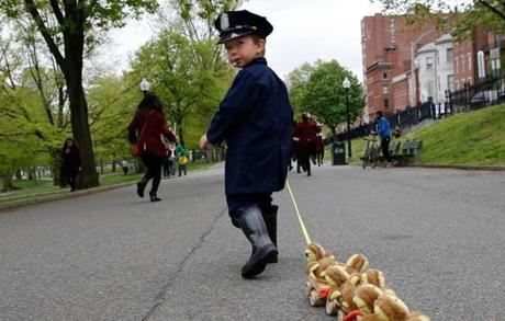 Jonathan Krygowski, 4, of Westford, blows the whistle as he leads the Duckling Day Parade, dressed as Michael from the children?s story ?Make Way for Ducklings.?
