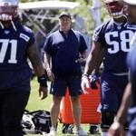 New England Patriots head coach Bill Belichick watches players during practice at the NFL football team's training camp in Foxborough, Mass., Thursday, May 31, 2018. (AP Photo/Charles Krupa)