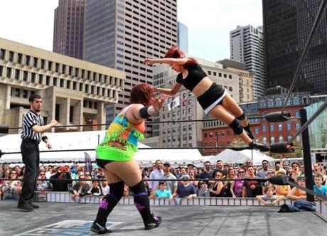 Professional wrestler Sierra Cardenas throws a cross body slam on wrestler Liz Bea. In honor of Cinco De Mayo, a taco festival was held on Boston City Hall Ptlaza, along with a full day of wrestling.
