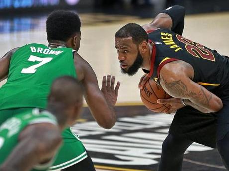 LeBron James of the Cleveland Cavaliers eyes his next movew as he is guarded by the Celtics? Jaylen Brown (7) in the fourth quarter of a game in Cleveland.
