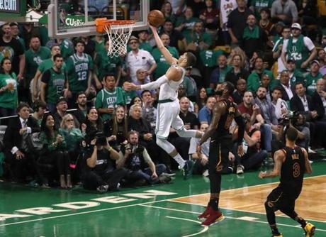 Jayson Tatum makes a fast break layup, beating Cleveland Cavaliers LeBron James and George Hil,l during an Eastern Conference Finals playoff game at TD Garden. 
