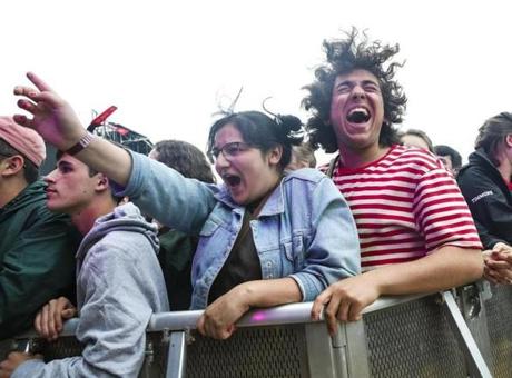 Fans Lauren McArthur and Kyle Benor (right) cheer as the band Alvvays performs at the Boston Calling music festival.
