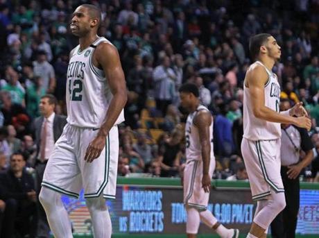 As the final seconds tick off in the seventh-game loss to the Cleveland Cavaliers, Boston Celtics Al Horford, Marcus Smart, and Jayson Tatum are pictured, with head coach Brad Stevens in the backrounds at TD Garden.
