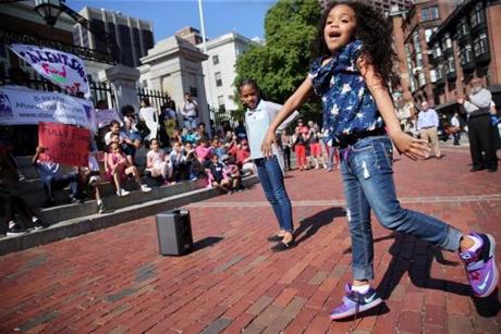 Jakaelie Castillo-Frias, a second-grader at Blackstone Innovation School, dances for the crowd during the ?Celebrate Our Future? student talent show at the State House.
