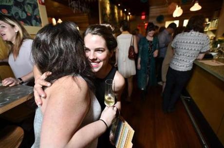 Co-owner Mary Kurth greets friend and patron Mandy Krumnow of Boston at Spoke Wine Bar?s reopening.
