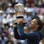 Romania's Simona Halep holds the trophy as she celebrates wining the final match of the French Open tennis tournament against Sloane Stephens of the U.S. in three sets 3-6, 6-4, 6-1, at the Roland Garros stadium in Paris, France, Saturday, June 9, 2018. (AP Photo/Alessandra Tarantino)
