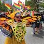 A woman in a butterfly outfit walked down Boylston Street during the Boston Pride Parade.