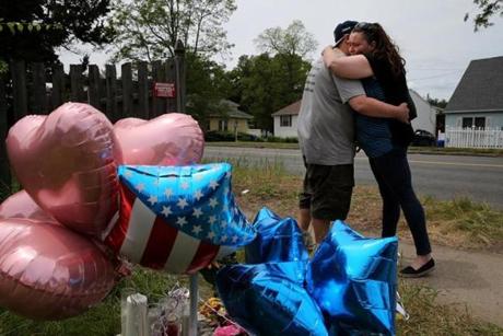 Eric and Maureen Glockenberg left balloons at a makeshift memorial outside the home of Stewart R. Weldon on Page Boulevard in Springfield.
