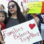 Letty Leal, with her daughter Alyssa, 2, of McAllen, Texas, joins a protest at the Border Patrol processing center in McAllen on Monday, June 25, 2018. (Delcia Lopez/The Monitor via AP)