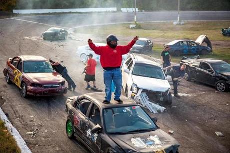 Dylan Fielding celebrates at the finish of the demolition-style Flagpole Race, held at the end of each racing day at New Hampshire?s Hudson Speedway.
