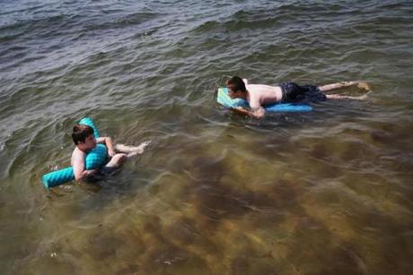 Two boys cooled off Monday in the water at Haigus Beach in Dennis.
