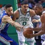 Boston, MA: 5-3-18: The 76ers Ben Simmons (left) is too late to get the loose ball that the Celtics Al Horford has just grabbed, Boston's Jayson Tatum is in the middle. The Boston Celtics hosted the Philadelphia 76ers in Game Two of their NBA Eastern Conference Semi Final playoff series at the TD Garden. (Jim Davis/Globe Staff)