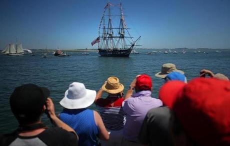 A crowd gathered Wednesday on a pier to photograph the USS Constitution as it came into view. The ship headed to Castle Island in South Boston for a turnaround.
