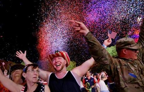 Boston, MA - July 04, 2018: Scott Webb, center, enjoys the festivities at the end of the Boston Pops Fireworks Spectacular at the Hatch Shell on the Esplanade in Boston, MA on July 04, 2018. (Craig F. Walker/Globe Staff) section: metro reporter:
